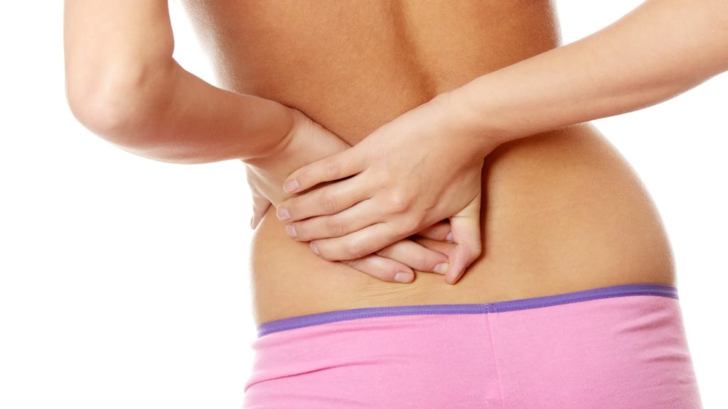 Woman holding back - Is your knee problem really a hip problem blog post