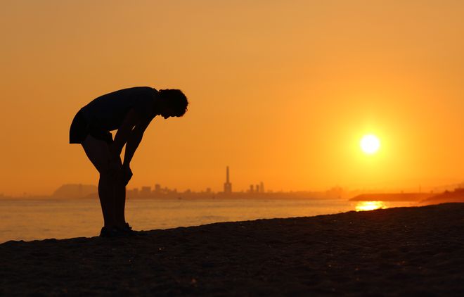 Jogger bending over outside by water - Time is precious…so, when you have so little of it, don’t waste it blog post