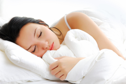 Woman sleeping in bed - Sleep is vital…so, here’s some tips to improve the quality of your sleep blog post